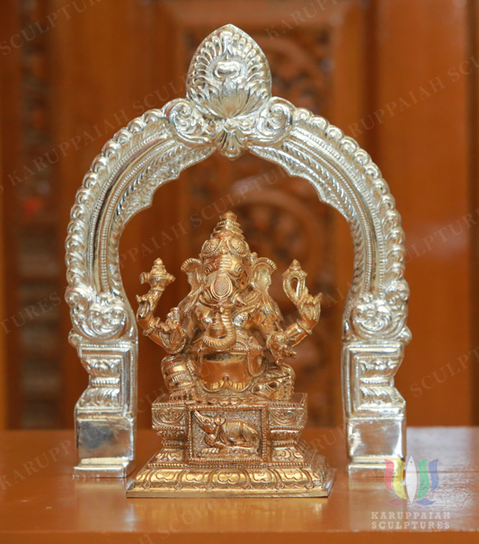 Bronze Ganesha statue with silver prabhavali to its behind